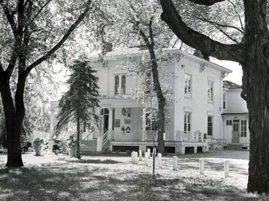 A black and white photo of the exterior of the Wustum Museum
